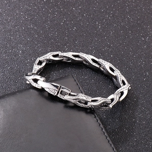Detail of silver stainless steel snake bone bracelet with interlocking links on leather