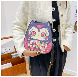 Detail view of owl-shaped crossbody bag with colorful feather prints and PU strap