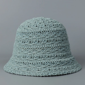 Detailed close-up of light blue knit texture and woven pattern on the bucket hat
