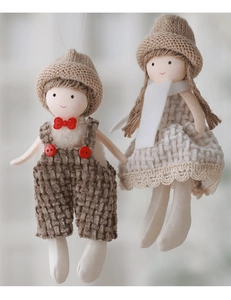 Detail of handmade Christmas angel plush dolls with knitted hats and fabric outfits
