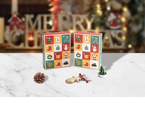 Detail of Christmas countdown calendar boxes on marble surface with festive holiday decor