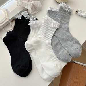 Three pairs of cotton crew socks with lace trim and satin bows in black, white, and grey