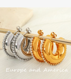 Detailed shot of gold and silver C-shaped hoop earrings with sparkling micro-pave stones