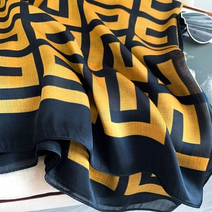 Detailed view of lightweight navy and gold geometric print scarf with sheer texture