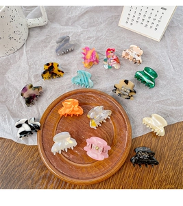 Detailed collection of mini acetate hair claw clips in assorted marble and tortoise patterns