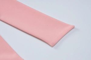 Detailed close-up of pink fabric texture and stitching on summer dress straps