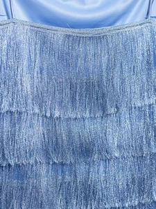 Close-up of blue fringe dress showing metallic shimmer yarn and satin texture detail