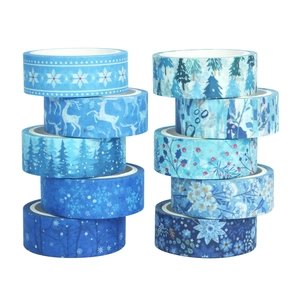 Detail of 10 rolls of blue winter washi tape with snowflakes and reindeer patterns