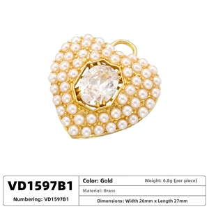 Close-up of golden heart pendant with inset zircon stone and white pearl border