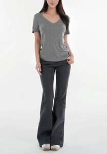 Front full-body shot of a grey V-neck T-shirt paired with dark grey flare denim jeans