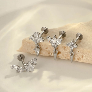 Silver star and flower zircon titanium labret stud earrings set on a textured stone