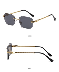 Close-up of frameless square sunglasses with rhinestone hinge and gold spiral metal arms