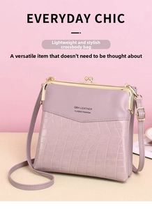 Detail view of lavender leather crossbody bag featuring crocodile pattern and gold clasp