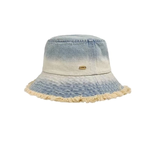 Frayed edge gradient denim bucket hat in light blue and beige with metal logo plate