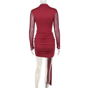 Detail view of the gathered mesh sleeve and ruched texture on this red bodycon mini dress