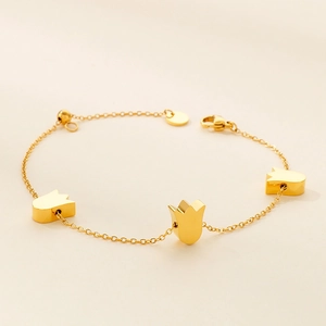 Detailed shot of gold-plated tulip charms on a titanium steel adjustable link bracelet