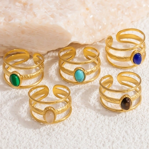 Detailed shot of multi-layer 18k gold rings featuring colorful natural stone insets