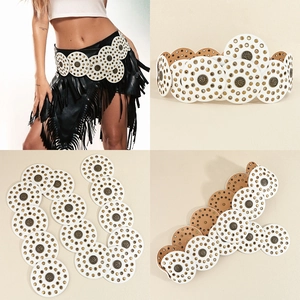 Detail view of white PU leather belt with round bronze rivets and boho cutout patterns