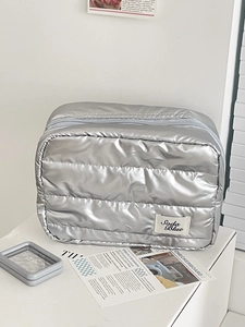 Silver quilted padded makeup bag with horizontal metallic finish for travel cosmetics