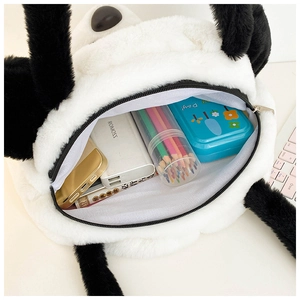 Internal capacity of large plush panda tote bag showing power bank and stationery