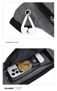Detail of gray sports waist bag featuring a built-in headphone port and front zipper pocket
