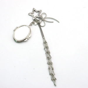 Silver star keychain with metal bow and long tassel charm for handbags or keys