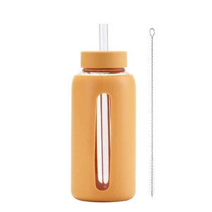 Detail of 800ml glass water bottle with orange silicone sleeve, straw, and cleaning brush
