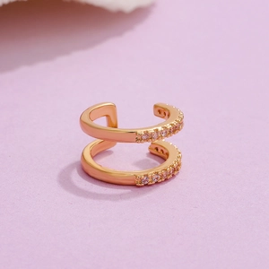 Detail of rose gold double-layer C-shaped ear cuff with sparkling pink zircons