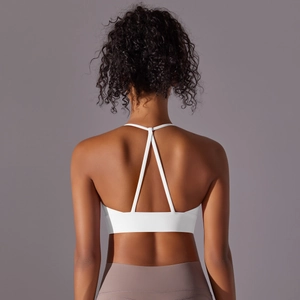 Close-up of white sports bra featuring back cross straps and high elasticity fabric texture