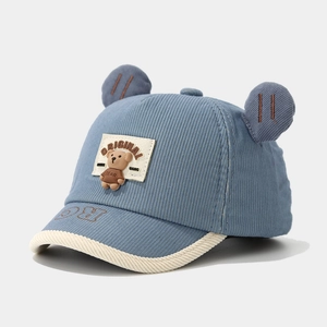 Close-up of blue corduroy baby baseball cap with 3D bear ears and animal character