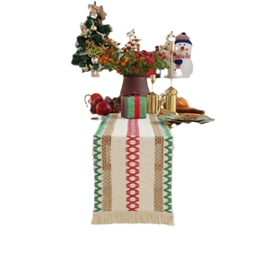 Christmas woven table runner with red and green geometric patterns and tassels decor