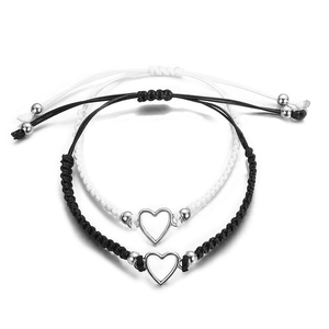 Adjustable black and white woven bracelets with hollow heart pendants for couples