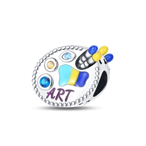 Macro shot of silver artist palette charm with enamel colors and ART engraving