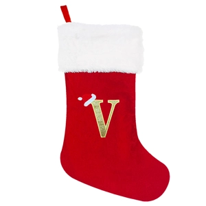 Detail of red velvet Christmas stocking with white trim and embroidered glitter letter V