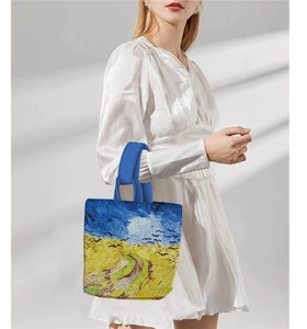 Detailed view of blue canvas bucket bag featuring Van Gogh's Wheatfield with Crows print