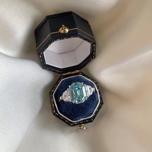 Macro shot of an S925 silver ring with blue zircon in a luxury vintage jewelry box