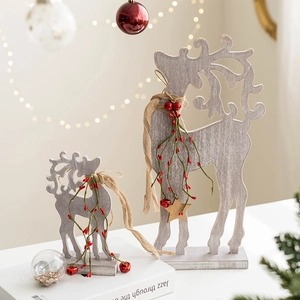 Creative wooden reindeer Christmas ornaments in grey wood finish with festive berry decor