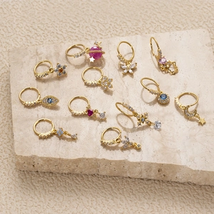 Golden hoop earrings set with colorful zircon charms including stars, moons and evil eyes