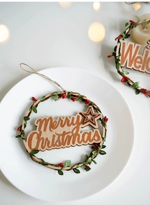 Detailed view of Merry Christmas wooden wreath with green leaves and red berries