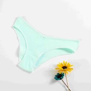 Detail of mint green ribbed cotton panties with V-shape waist on white background