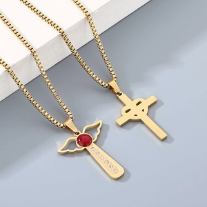 Golden cross necklace with wings, red gemstone, and a minimalist hollow cross pendant
