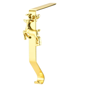 Detail of a golden metal reindeer Christmas stocking holder for fireplace mantels