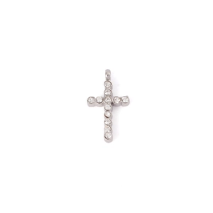 Macro shot of silver stainless steel cross pendant with sparkling inlaid crystals