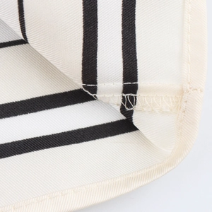 Macro detail of high-quality stitching and black white striped satin fabric texture