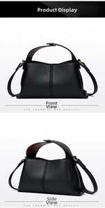 Close-up of black litchi grain leather texture and gold hardware on square handbag