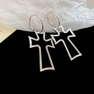 Detail of silver oversized hollow cross hoop earrings with black enamel on wrinkled paper