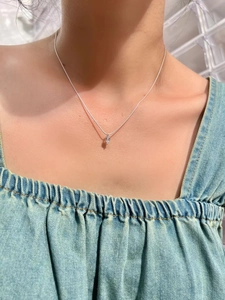 Detailed view of a 925 sterling silver necklace with marquise zircon worn by a model