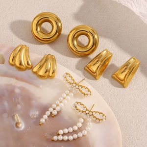 Detail of 18K gold-plated earrings set with trapezoid geometric studs and pearl bows