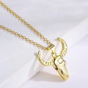 18K gold plated necklace featuring a detailed bull skull pendant with red eye accents
