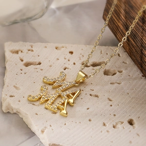 18K gold plated necklace featuring MAMA pendant with clear cubic zirconia on stone surface
